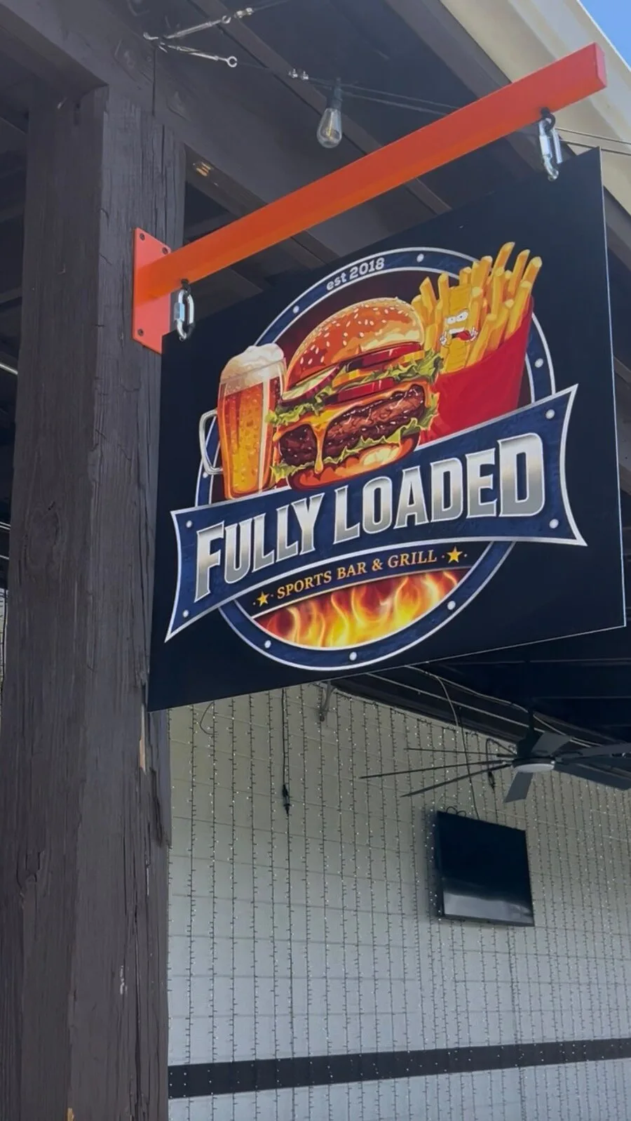 Fully Loaded Sports Bar & Grill outdoor sign by the entrance