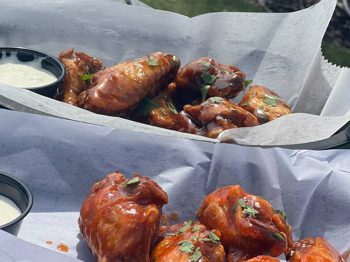 Saucy wings served outside with ranch for Wing Wednesday